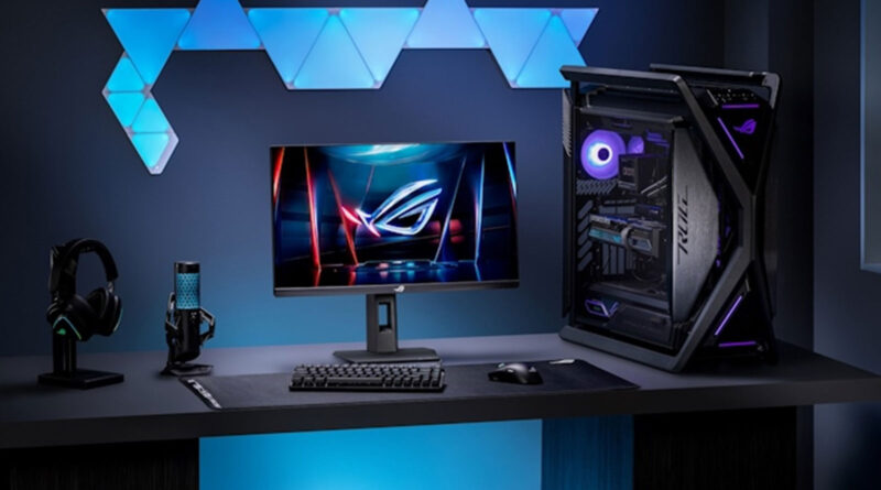 Escritorio de juego iluminado con un monitor ROG Strix, teclado, ratón, auriculares y una torre de PC con LED RGB.