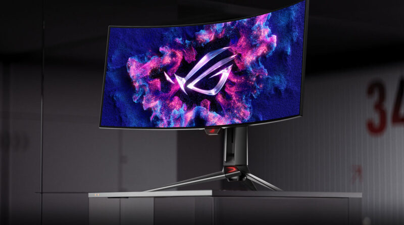 Monitor curvo con fondo oscuro y diseño vibrante, presenta el logo de ROG en colores rosa y azul, montado sobre un soporte plateado.