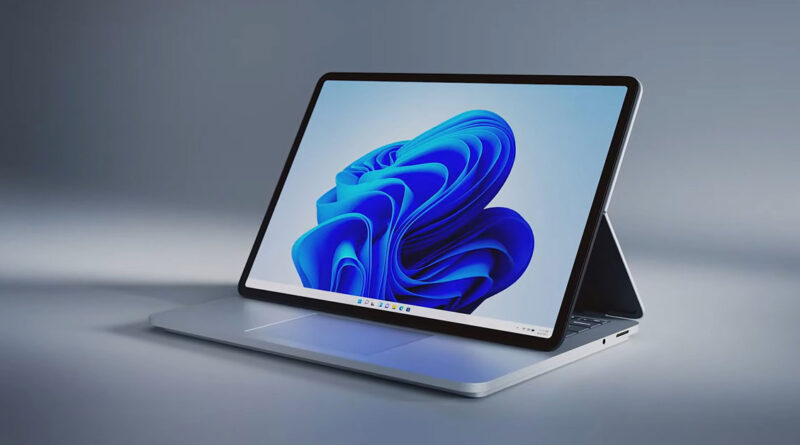 Portátil Surface con pantalla grande y diseño elegante, mostrando el logo de Windows 11 en un fondo gris frío.