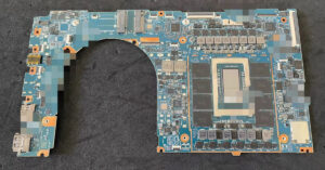 Placa madre de laptop con componentes electrónicos visibles, en tonos azules y negros, destacando el área del procesador.