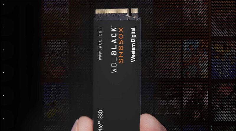 SSD WD Black SN850X en mano, con fondo oscuro, destacando su diseño elegante y el logo de Western Digital en colores negro y naranja.