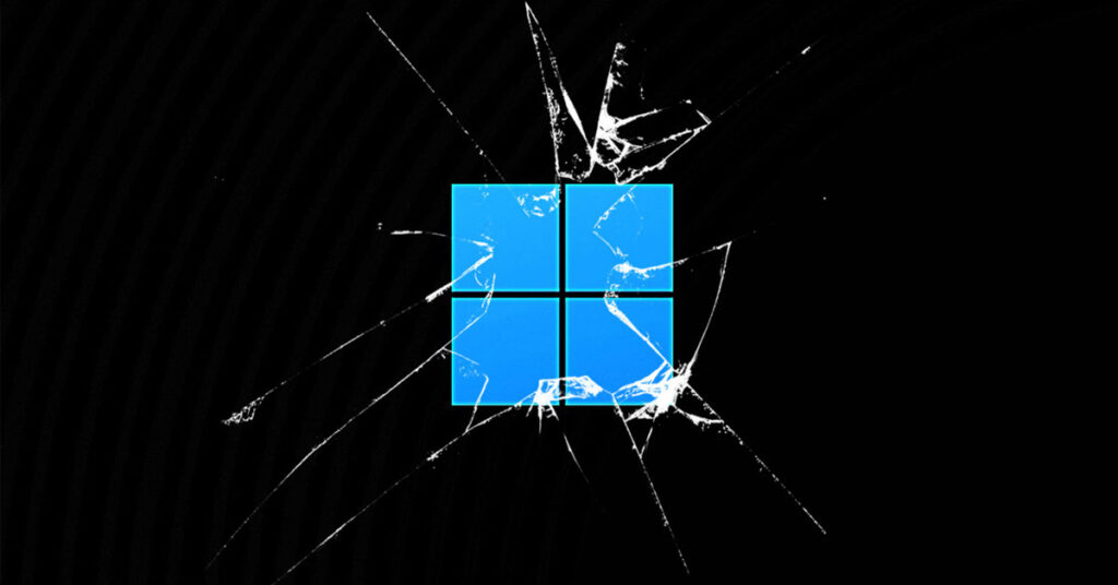 Logotipo de Windows 11 en azul, con un efecto de grietas en un fondo negro, simbolizando un fallo o daño en el sistema.