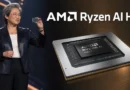 Mujer sosteniendo un chip Ryzen AI Halo en un fondo oscuro con detalles en dorado y el logo de AMD a la derecha.