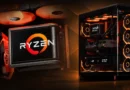 Ensamblaje de PC gamer con componentes AMD, iluminación naranja, disipadores prominentes y logo de Ryzen destacado.