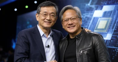 Dos hombres sonrientes, uno con gafas y traje oscuro, el otro en chaqueta de cuero, posan juntos ante un fondo tecnológico azul.