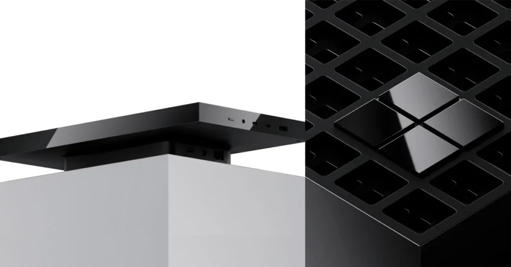 Dispositivo rectangular negro en la parte superior de un soporte blanco, junto a una estructura negra con diseño de rejilla.