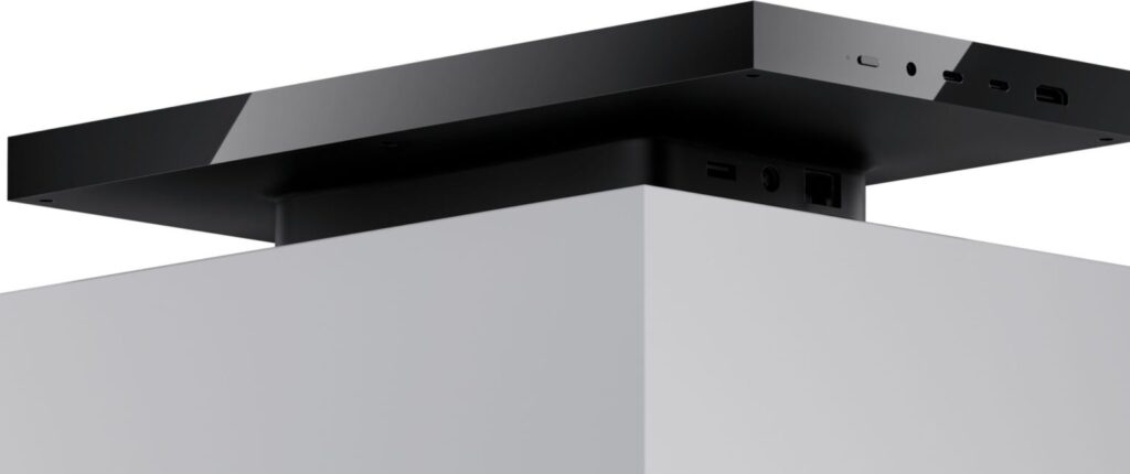 Diseño minimalista de una torre de hardware en blanco y negro, con múltiples puertos en la parte superior y frontal.